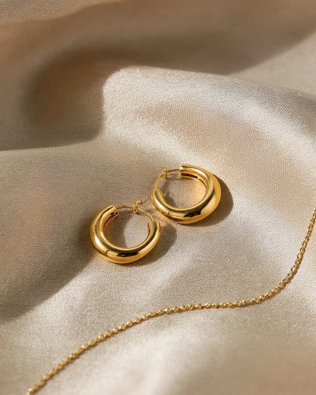 Concepto generado con IA: joyería dorada sobre seda beige